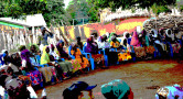 people sitting around outside in circle on chairs