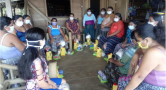 women sitting in circle wearing masks