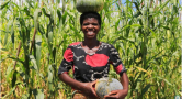 Woman smiling in front of corn field